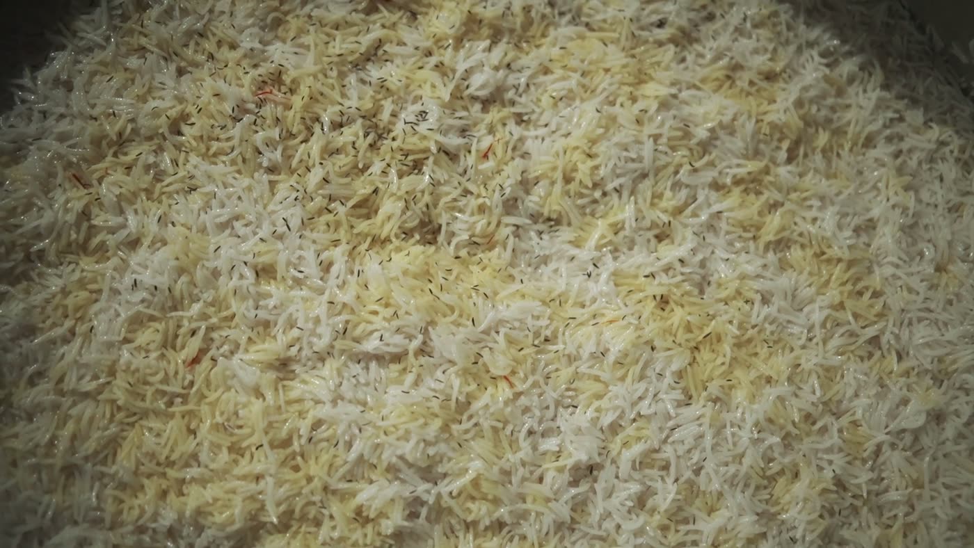 Cooked biryani filling a handi to the brim