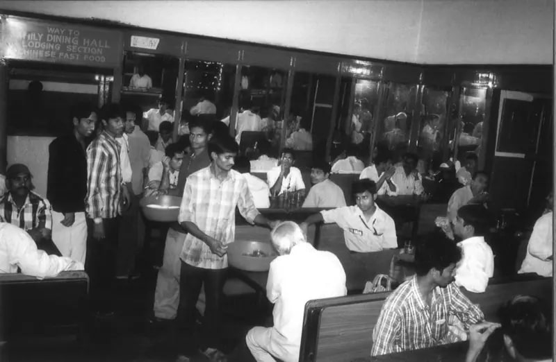 Diners at tables in Grand Hotel's dining hall, in black and white, between the 1980s and 2000s